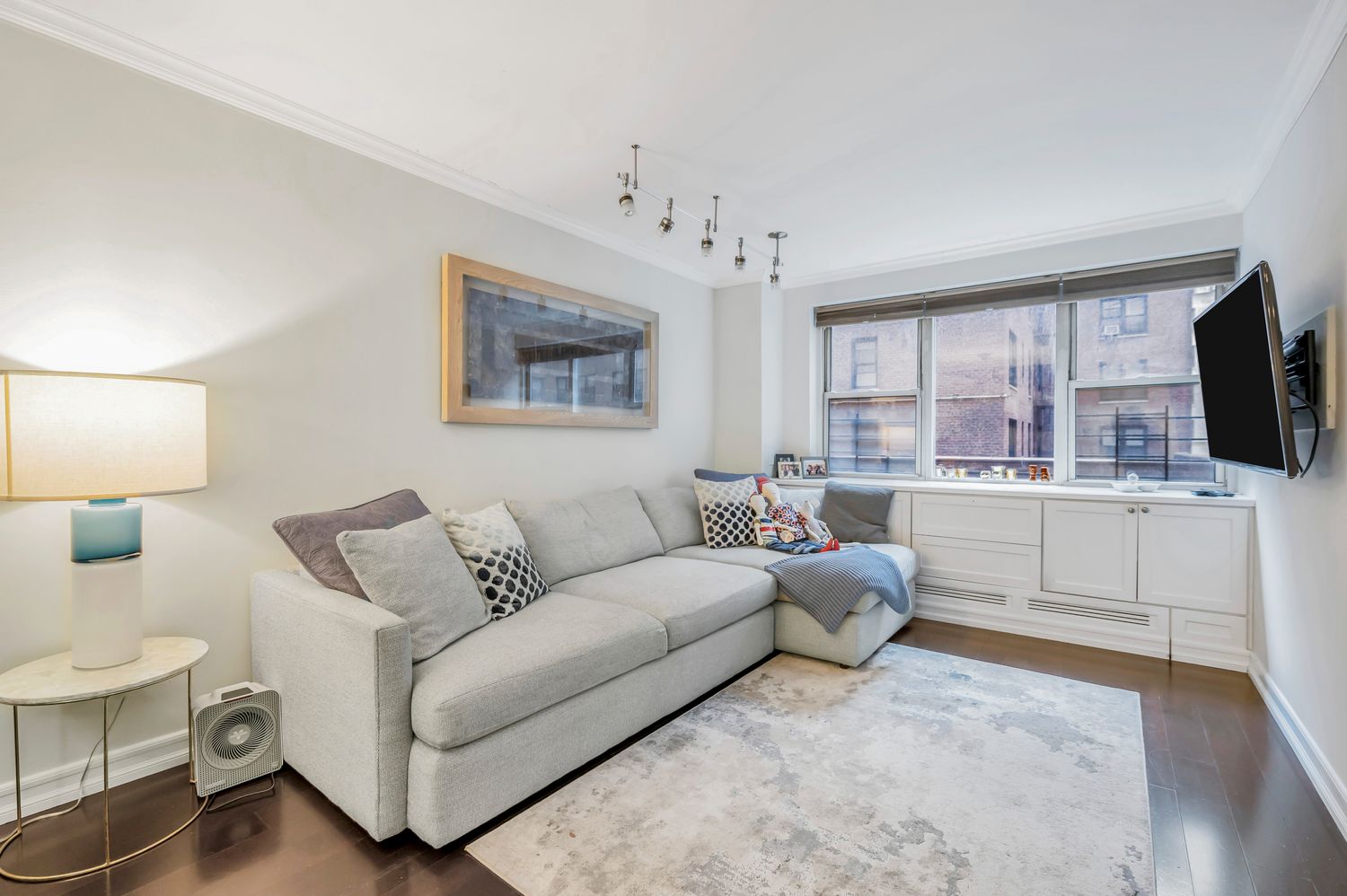 333 East 79th Street, Unit 2R Manhattan, NY 10075 - Photo 2 of 13 a living room with furniture a flat screen tv and kitchen view