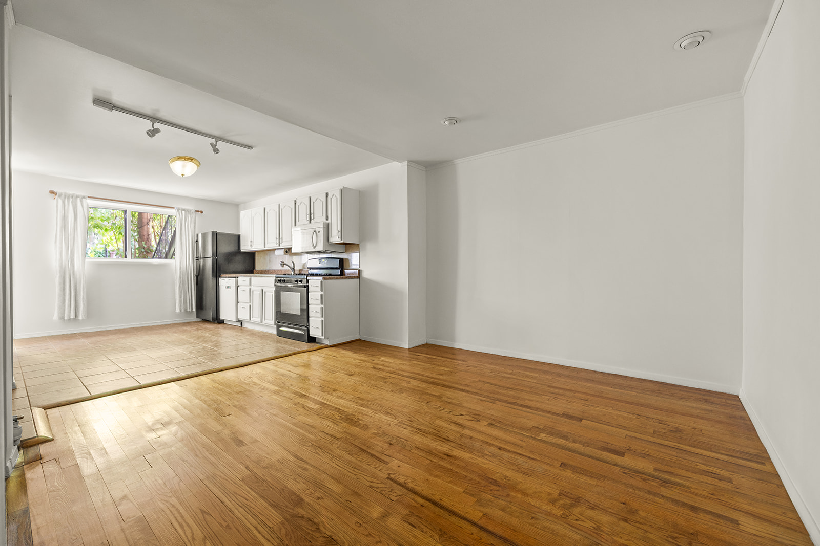 726A Union Street, Unit 1 Brooklyn, NY 11215 - Photo 5 of 13 a view of a kitchen with a sink and a refrigerator