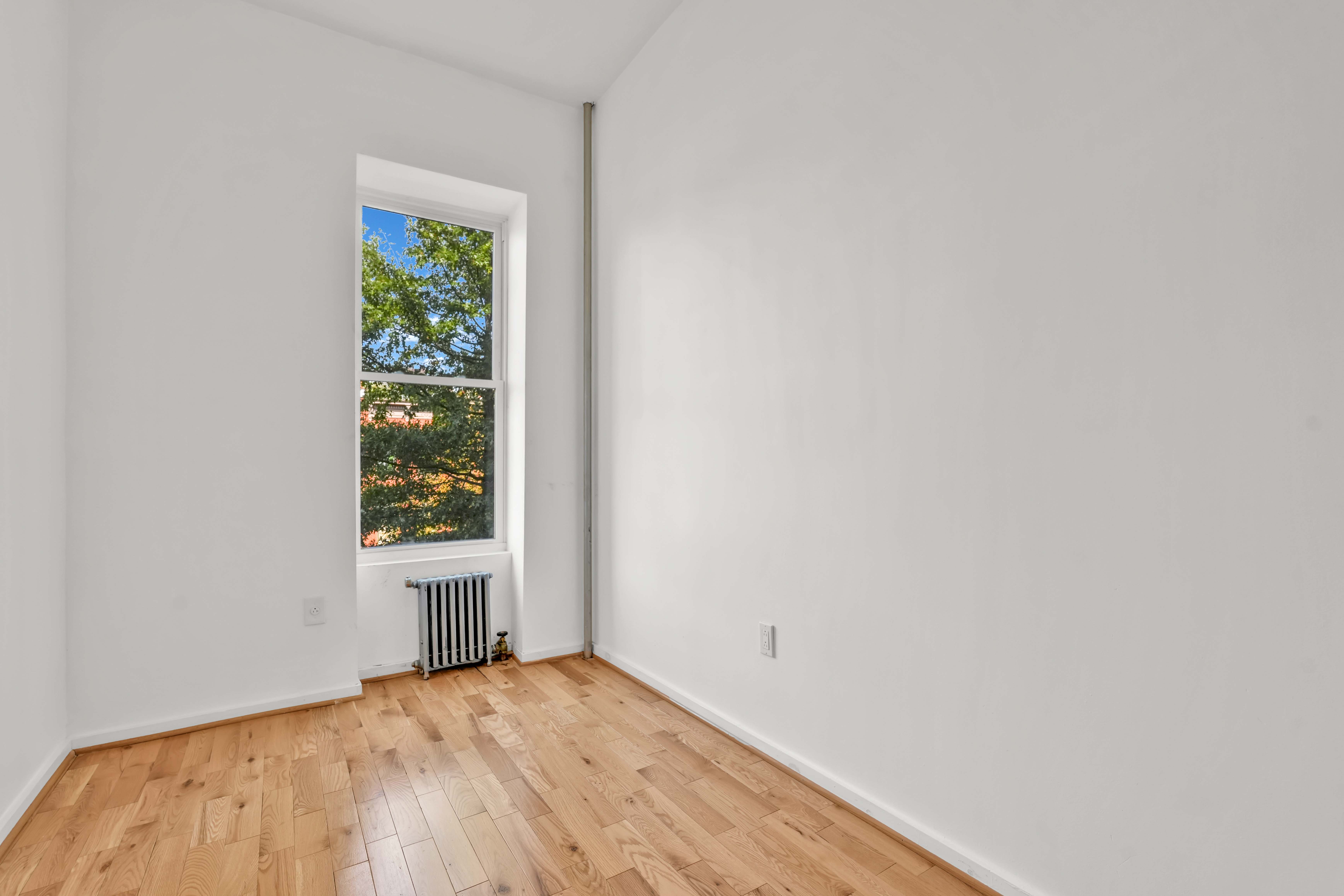238 Vernon Avenue, Unit 2 Brooklyn, NY 11206 - Photo 14 of 21 a view of an empty room and window