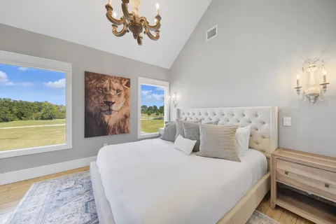 a living room with a bed furniture and a chandelier