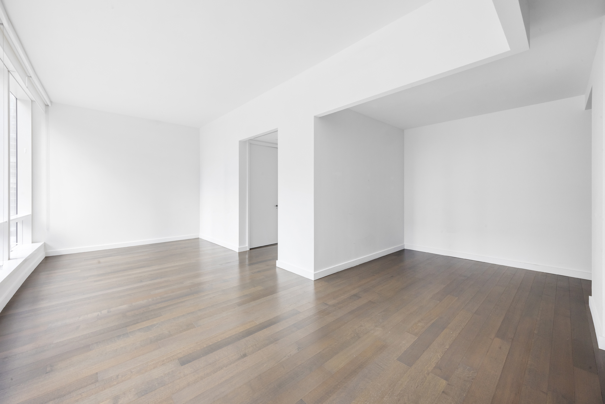 111 Murray Street, Unit 7D Manhattan, NY 10007 - Photo 10 of 17 a view of an empty room with wooden floor and a window
