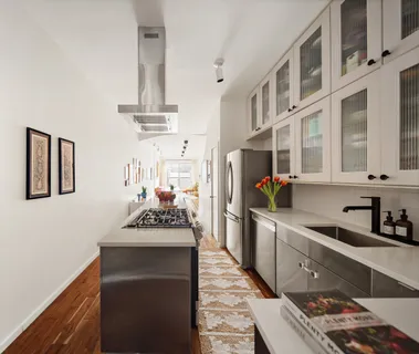 a kitchen with stainless steel appliances a sink and cabinets