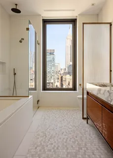 a view of bathroom with bathtub and shower