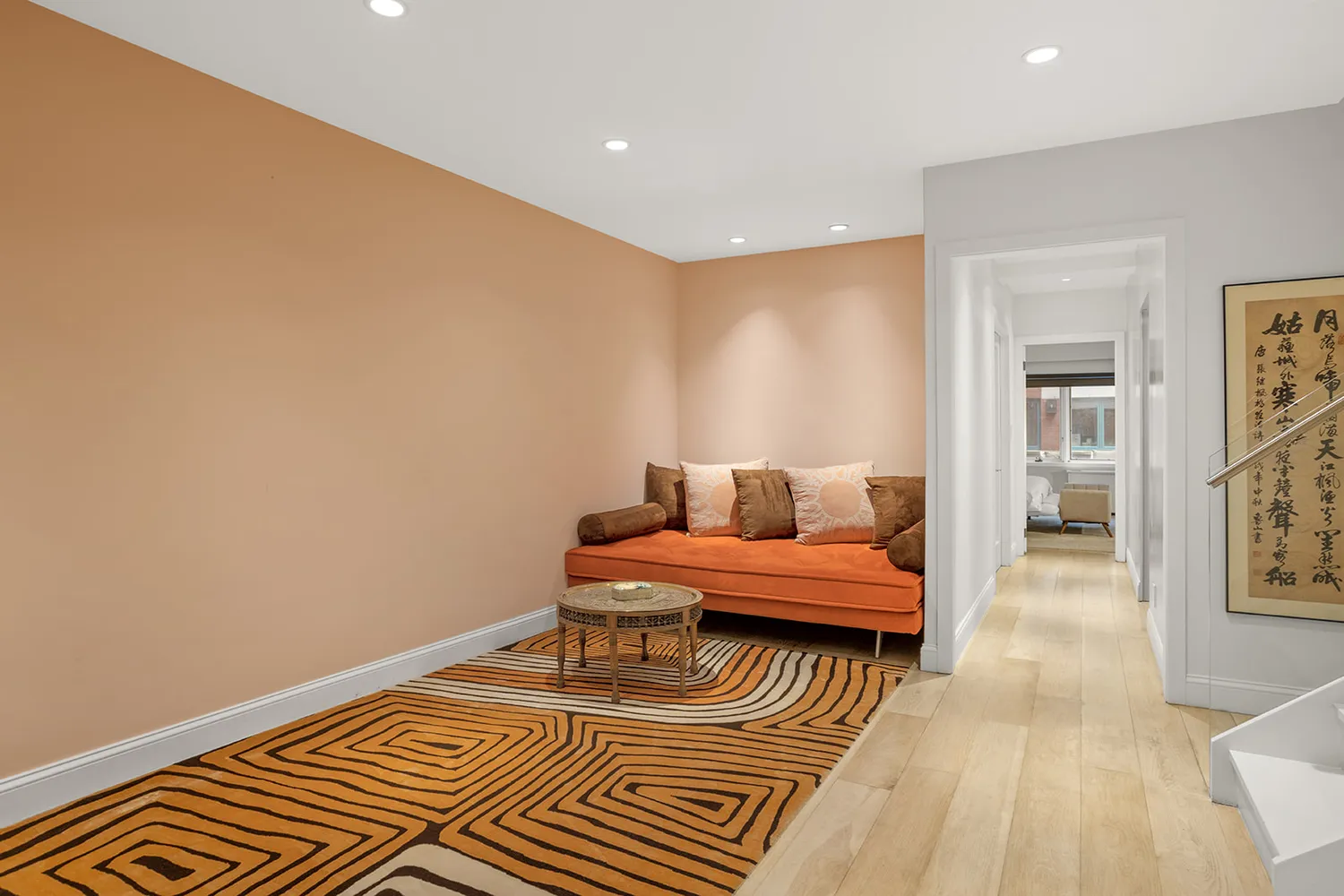 a spacious bedroom with a bed and wooden floor