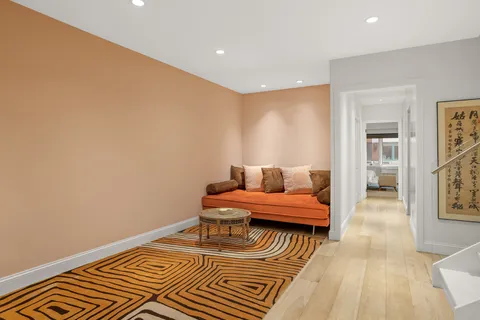 a spacious bedroom with a bed and wooden floor