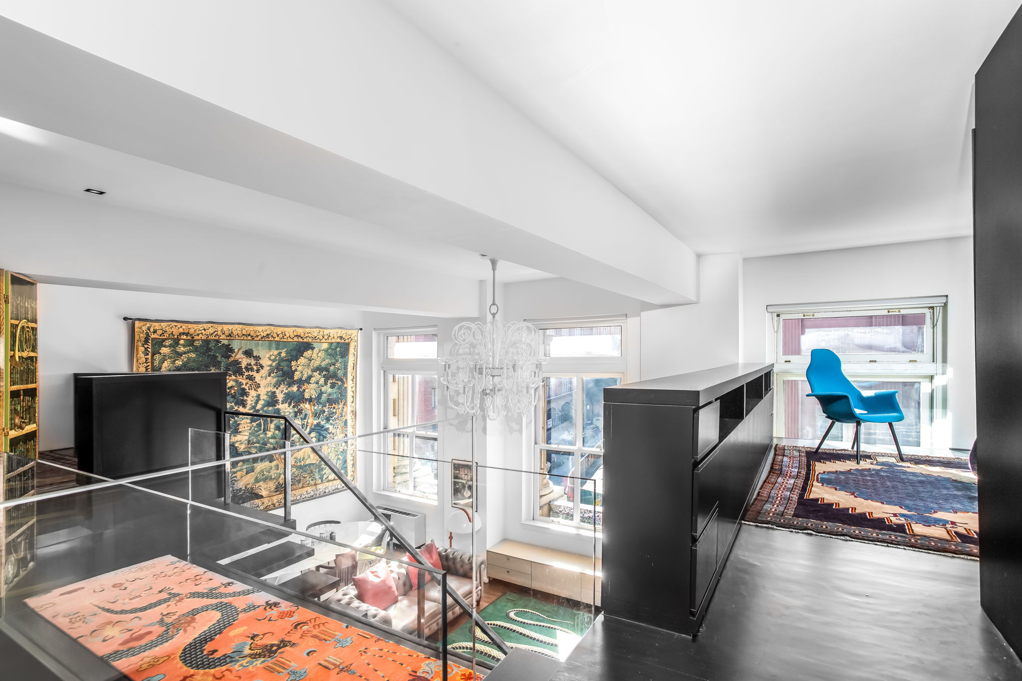 240 Centre Street, Unit 3H Manhattan, NY 10013 - Photo 8 of 20 a living room with furniture a flat screen tv and floor to ceiling window