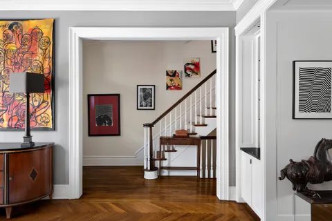a spacious bedroom with a bed and wooden floor