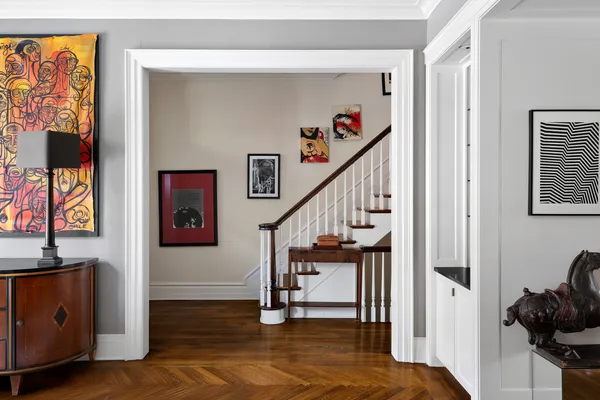 a spacious bedroom with a bed and wooden floor