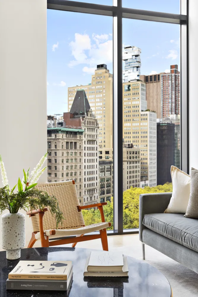 a living room with furniture and a floor to ceiling window