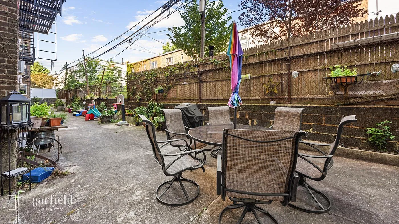 a view of patio with table and chairs and potted plants