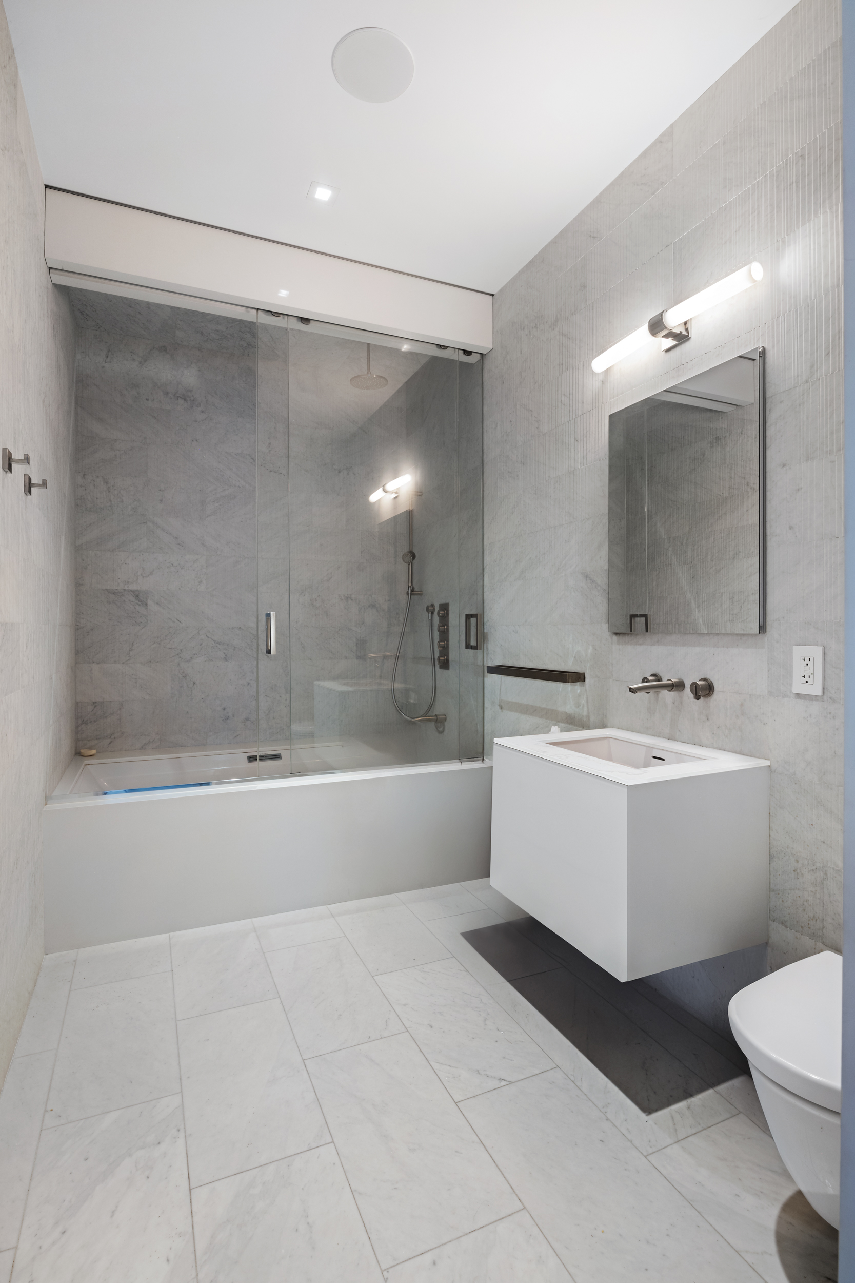 42 White Street, Unit PH Manhattan, NY 10013 - Photo 17 of 22 a bathroom with a bathtub shower sink mirror and toilet