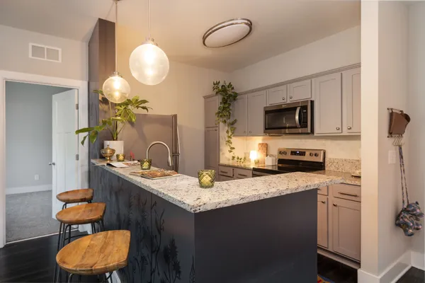 a kitchen with a sink refrigerator and microwave