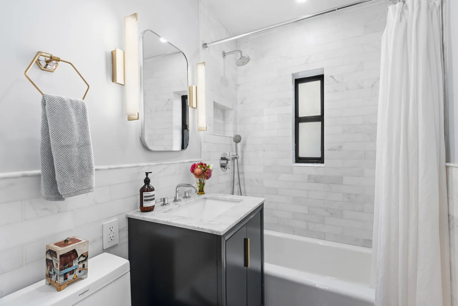 a bathroom with a sink vanity tub and a mirror