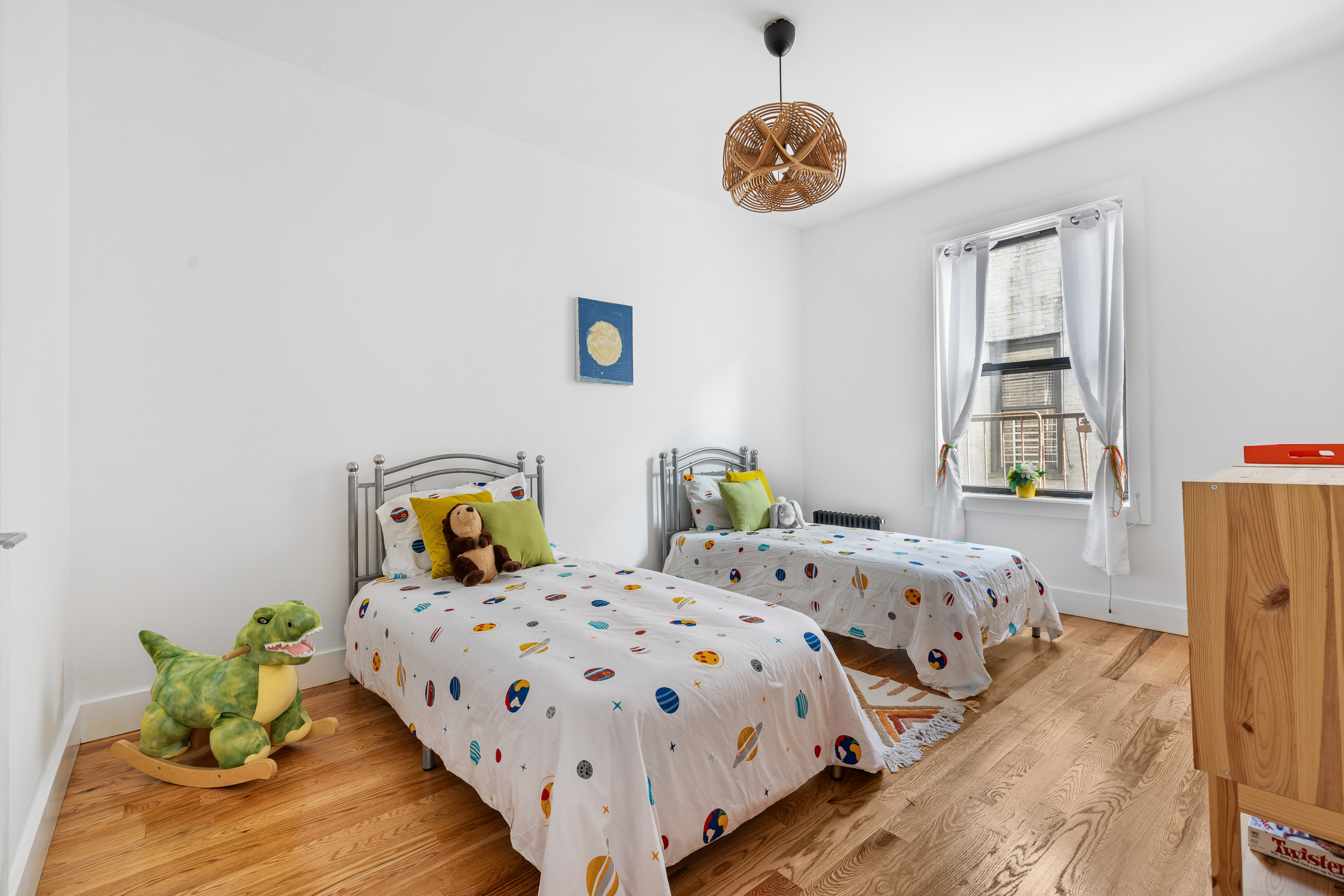 839 East 19th Street, Unit 4D Brooklyn, NY 11230 - Photo 4 of 10 a bedroom with two beds and a table