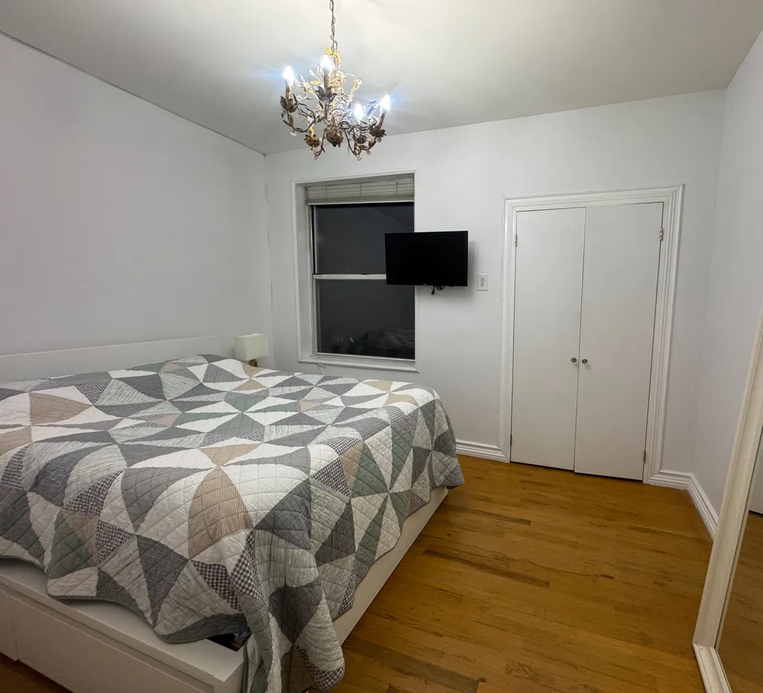 a bedroom with a large bed and a tv