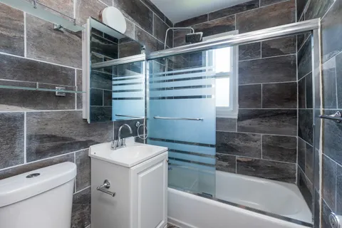 a bathroom with a sink toilet and tub