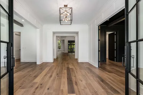 a view of a hallway with wooden floor