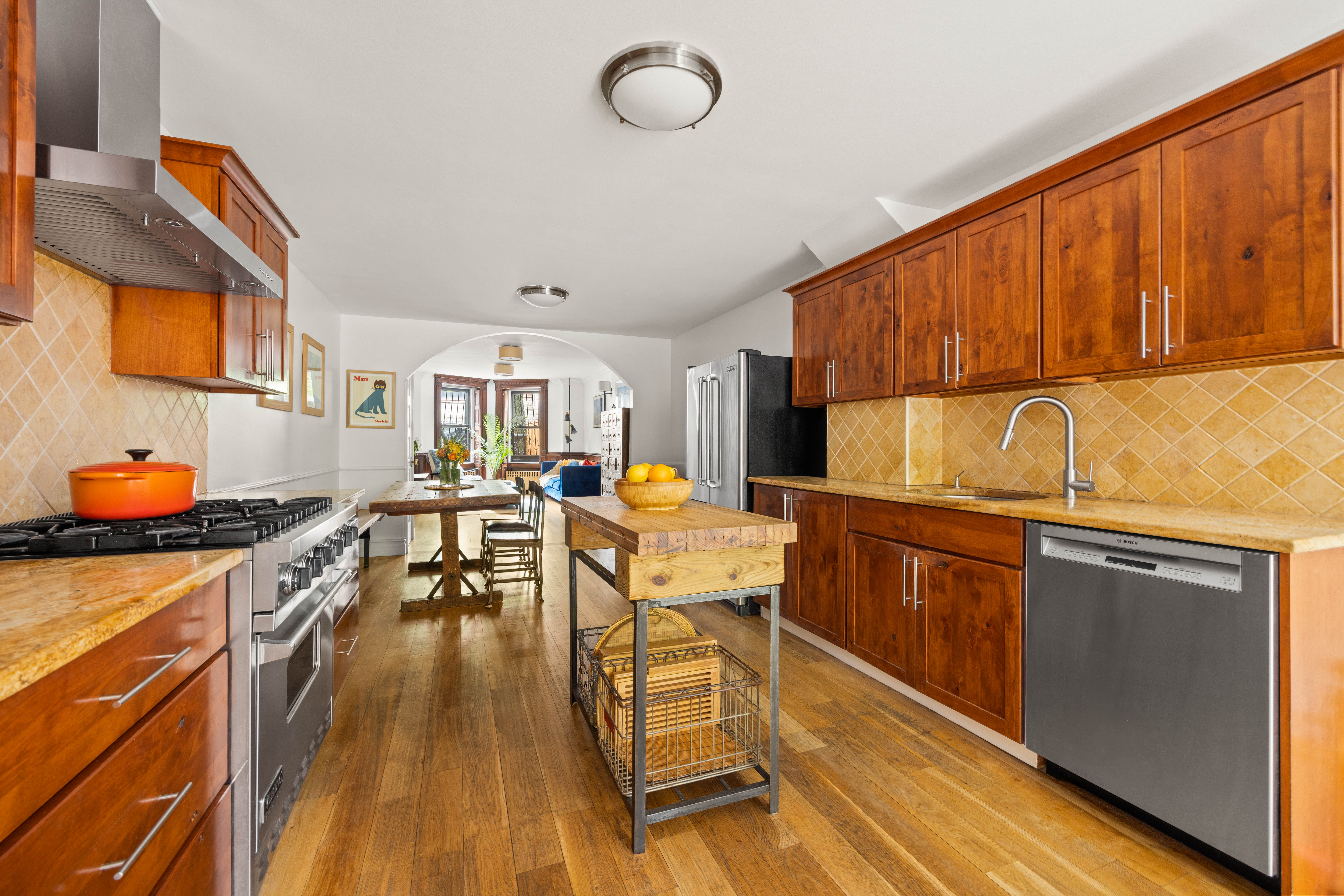 38 7th Avenue, Unit 1 Brooklyn, NY 11217 - Photo 3 of 13 a kitchen with stainless steel appliances granite countertop a stove top oven a sink dishwasher and cabinets with wooden floor