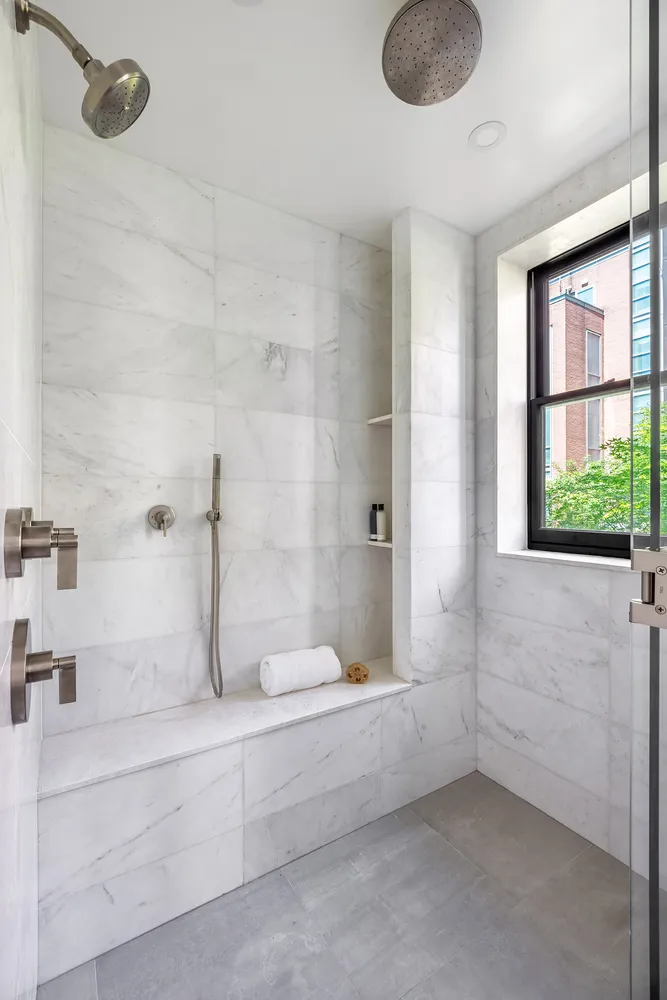 a bathroom with a granite countertop sink and a bathtub