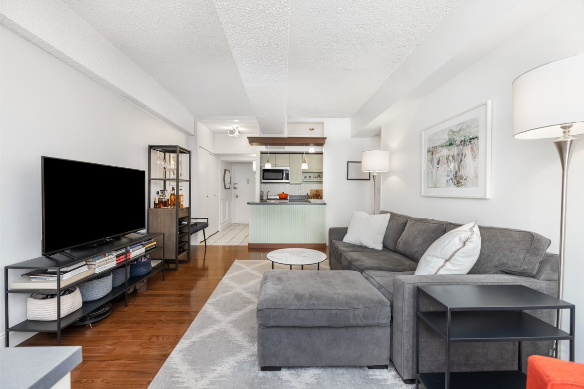 96 Schermerhorn Street, Unit 2F Brooklyn, NY 11201 - Photo 3 of 10 a living room with furniture and a flat screen tv