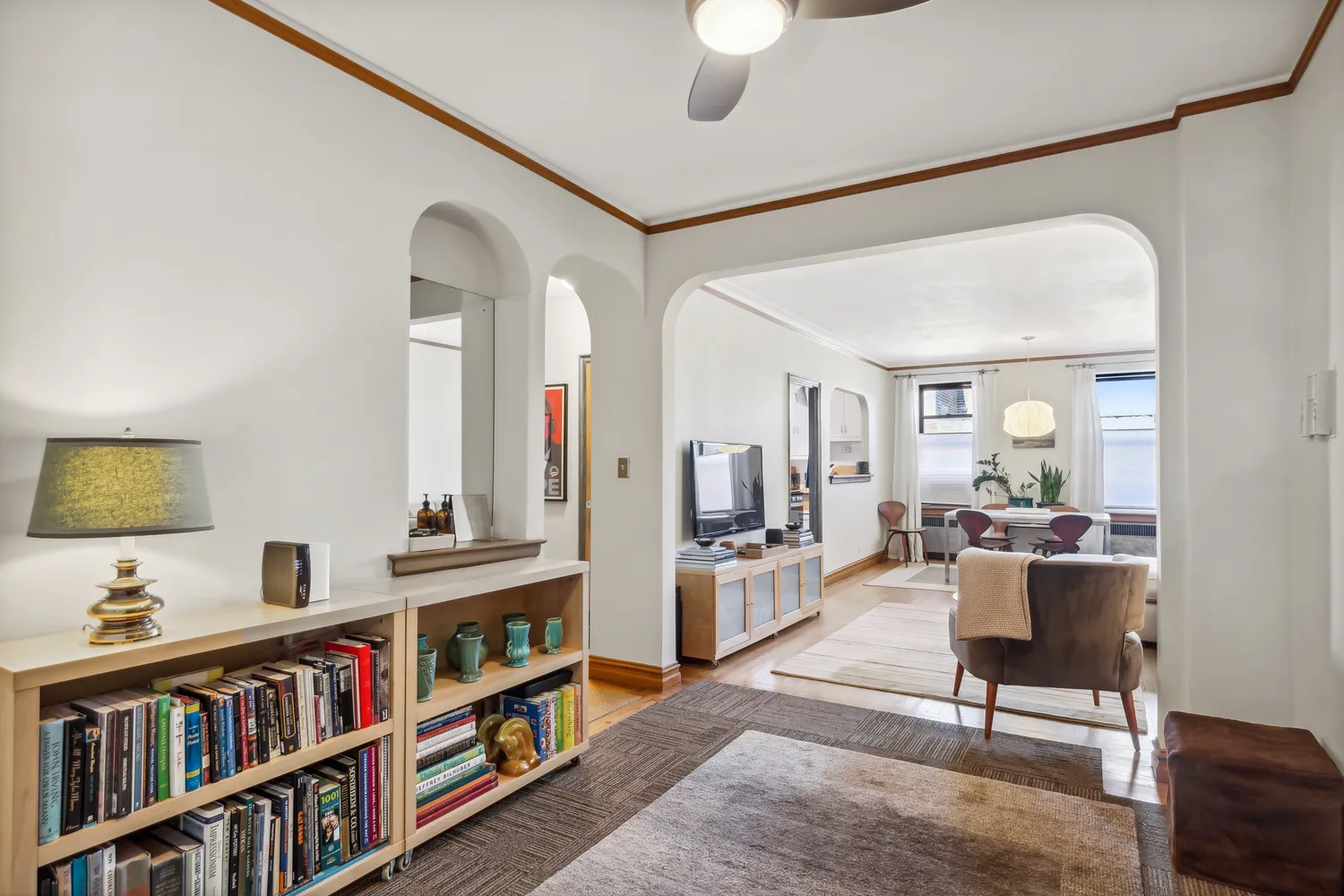 a living room with furniture and a book shelf