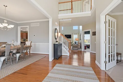 a view of a livingroom kitchen and dining room with wooden floor