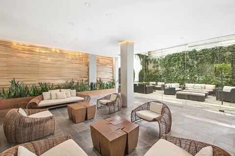 a balcony with furniture and a floor to ceiling window