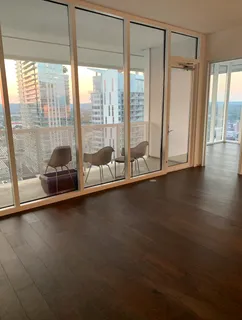 a view of room with window and wooden floor