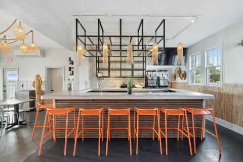 a large white kitchen with a large window