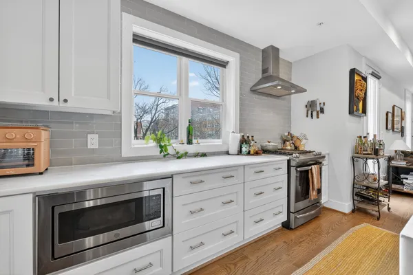 a kitchen with stainless steel appliances a stove a sink and a refrigerator