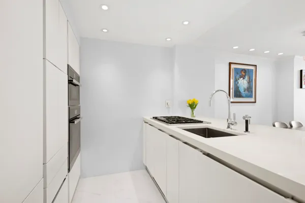 a kitchen with a sink and refrigerator