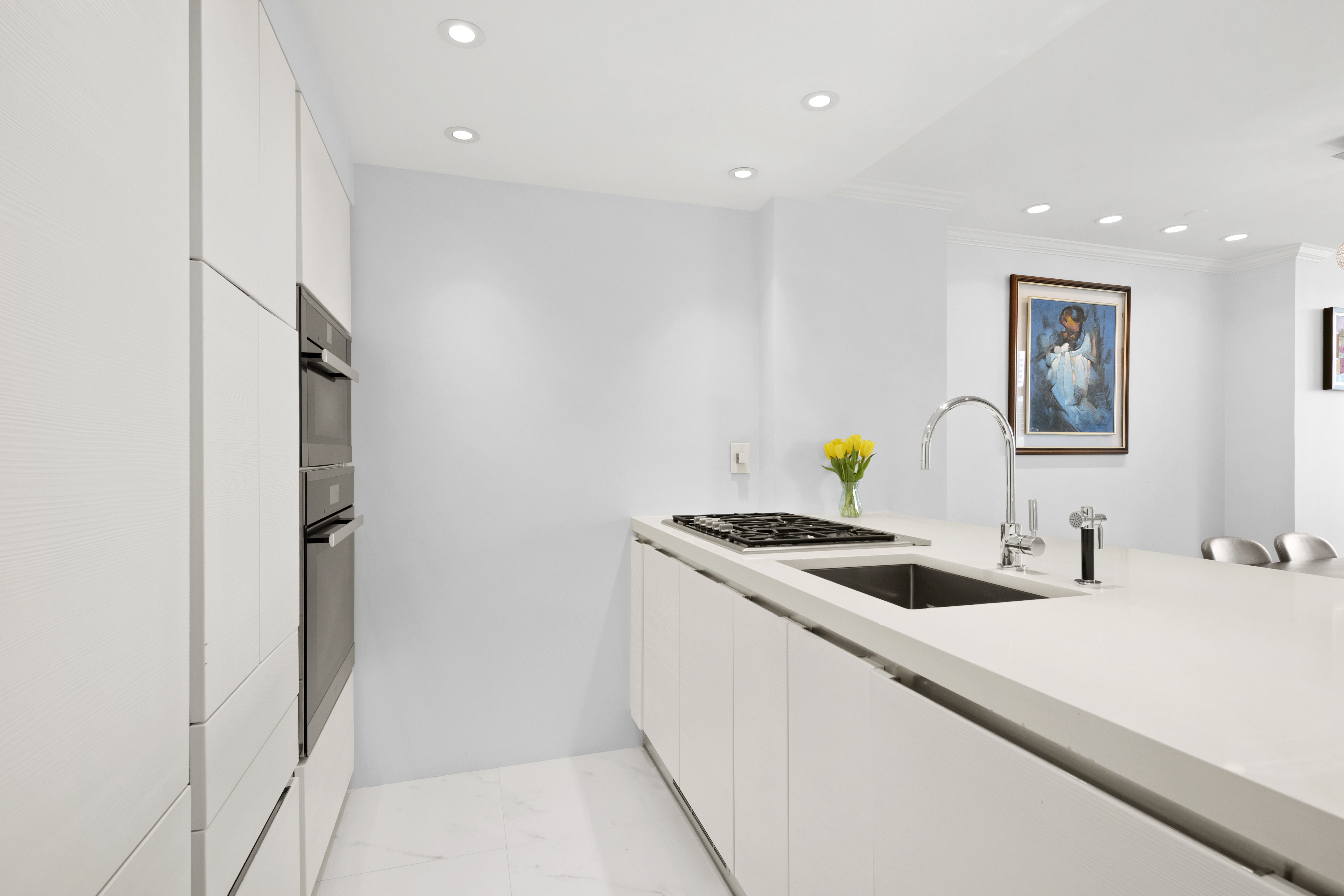 404 East 76th Street, Unit 17A Manhattan, NY 10021 - Photo 4 of 18 a kitchen with a sink and refrigerator