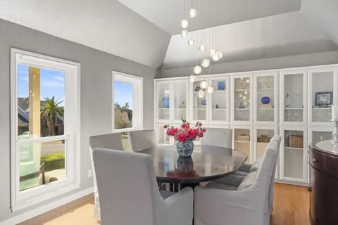 a view of a dining room with furniture and a potted plant