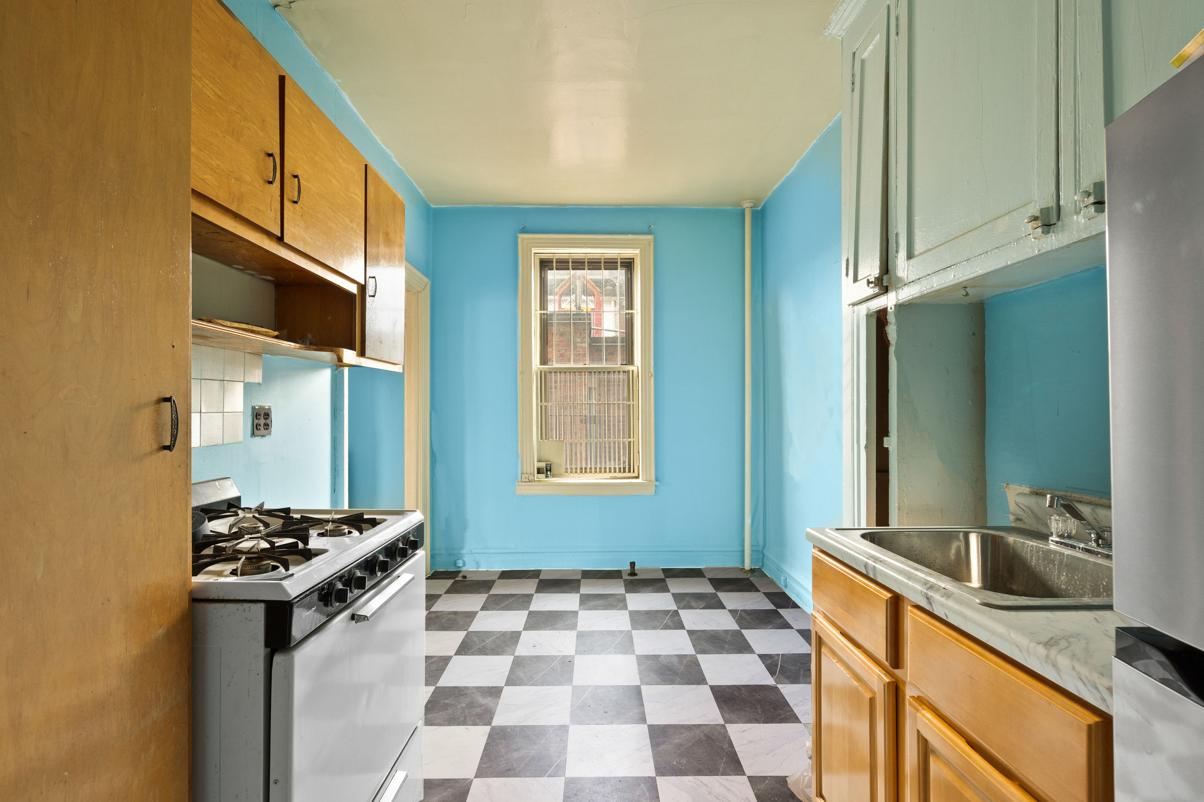 345 Montgomery Street, Unit 3C Brooklyn, NY 11225 - Photo 8 of 17 a kitchen with a sink a stove and a refrigerator