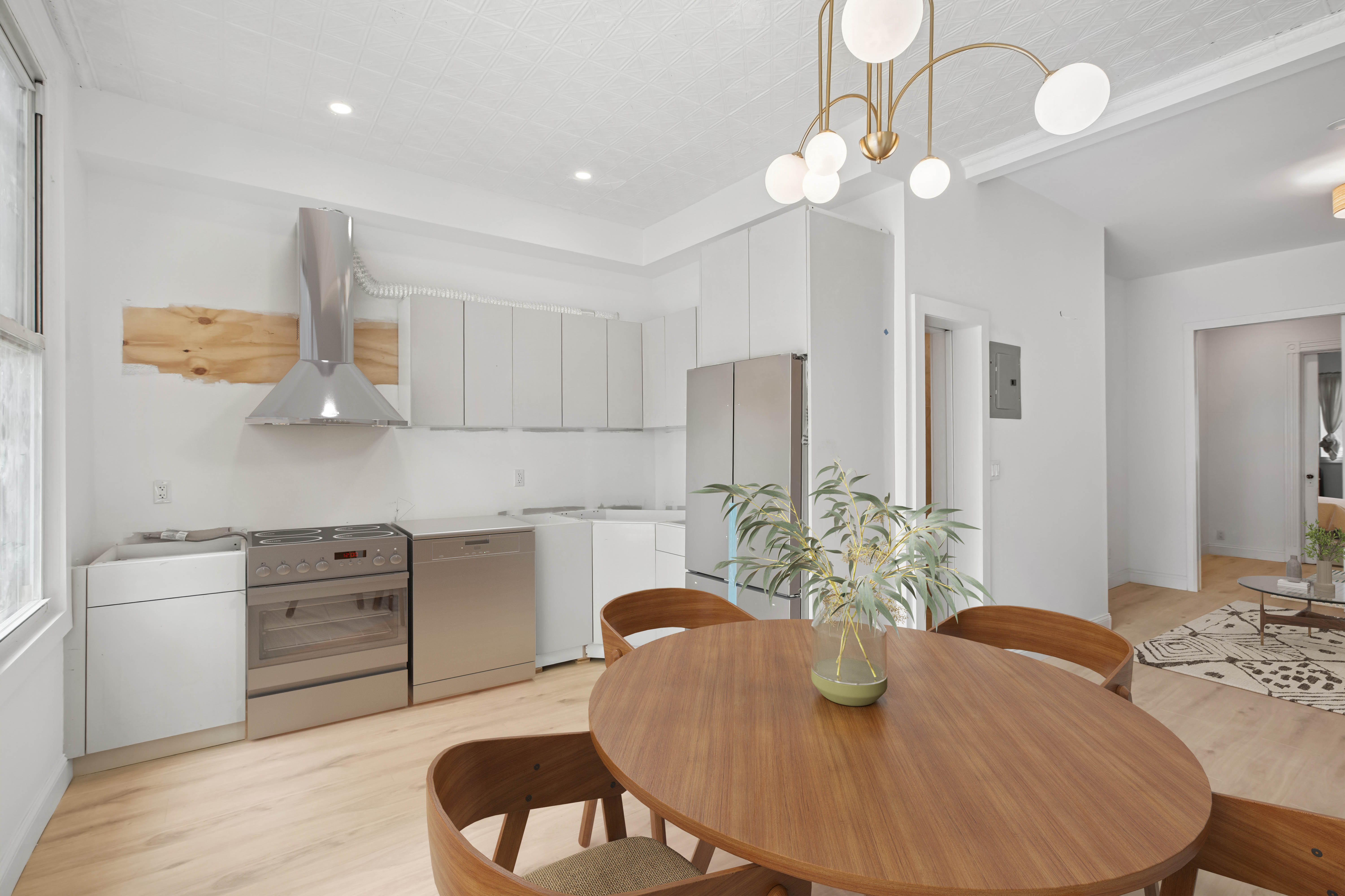35 Jewel Street, Unit 1 Brooklyn, NY 11222 - Photo 4 of 11 a kitchen with stainless steel appliances granite countertop a dining table chairs and a refrigerator