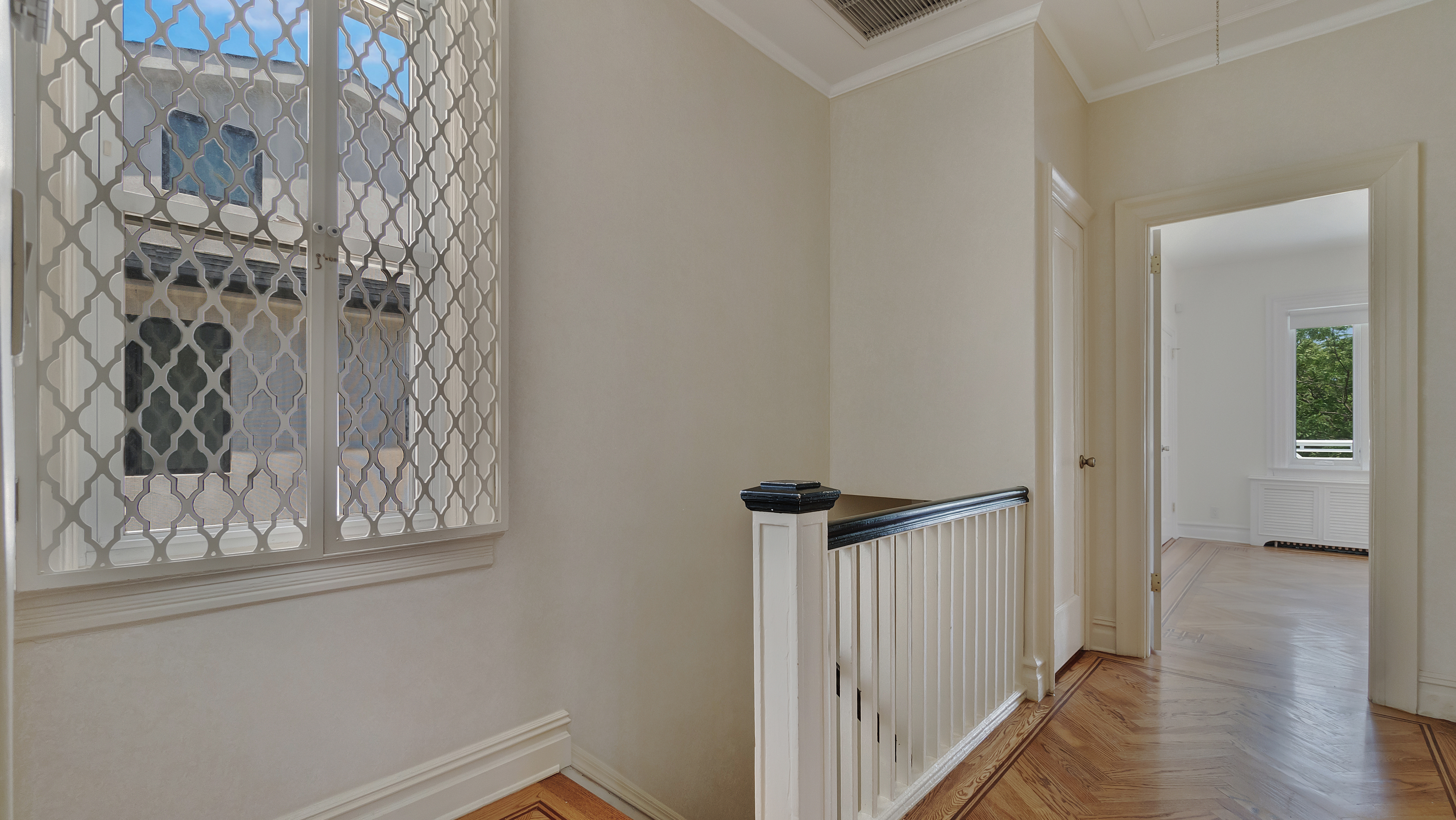 278 Amherst Street Brooklyn, NY 11235 - Photo 18 of 24 a view of a hallway with wooden floor and staircase
