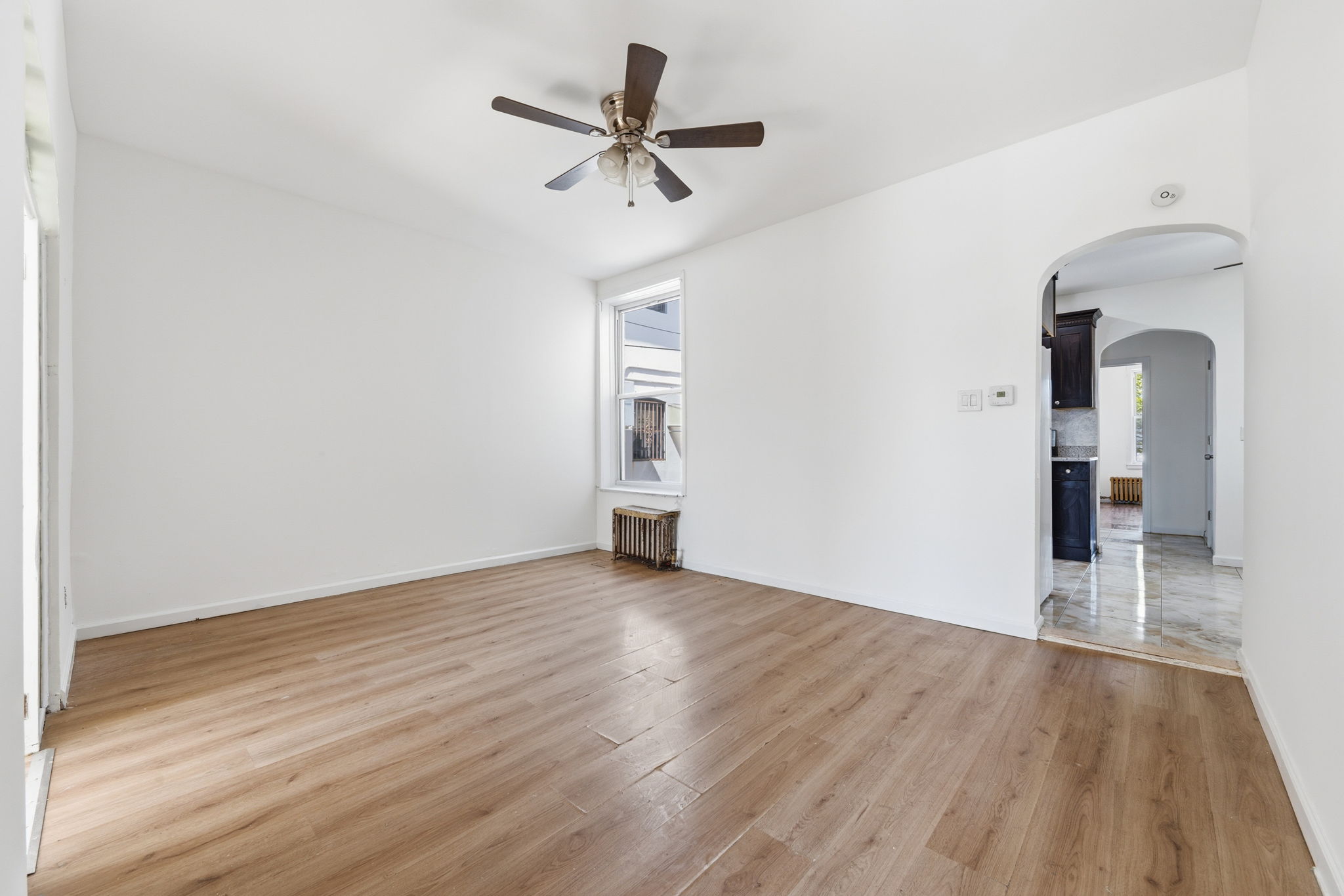 37 Chester Avenue Brooklyn, NY 11218 - Photo 4 of 14 a view of empty room with wooden floor and ceiling fan