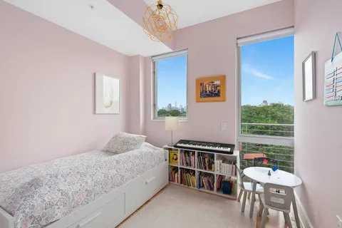 a bedroom with a bed and a book shelf