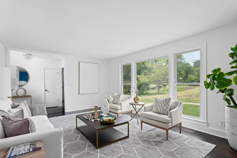 a living room with furniture fireplace and a window