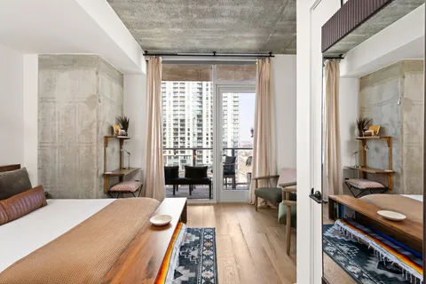 a bedroom with a bed and a large window