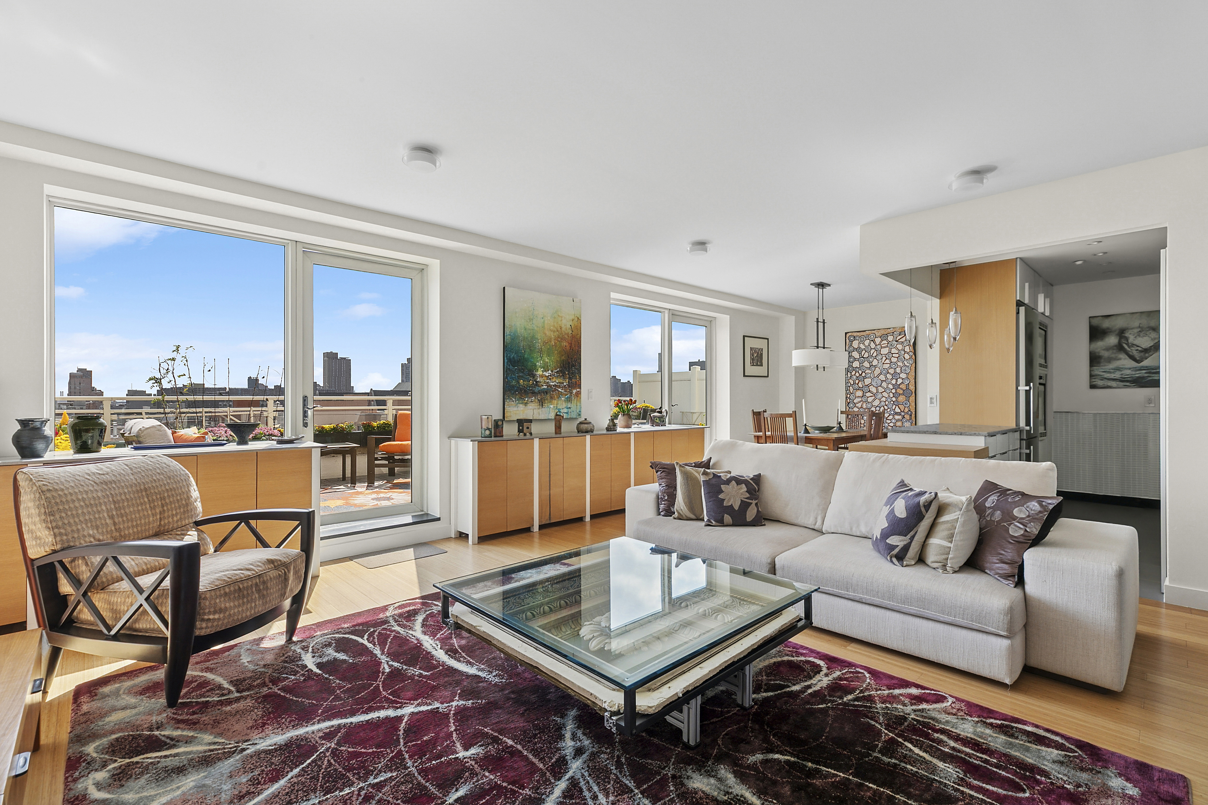 301 West 115th Street, Unit PH1C Manhattan, NY 10026 - Photo 4 of 12 a living room with furniture and a view of kitchen