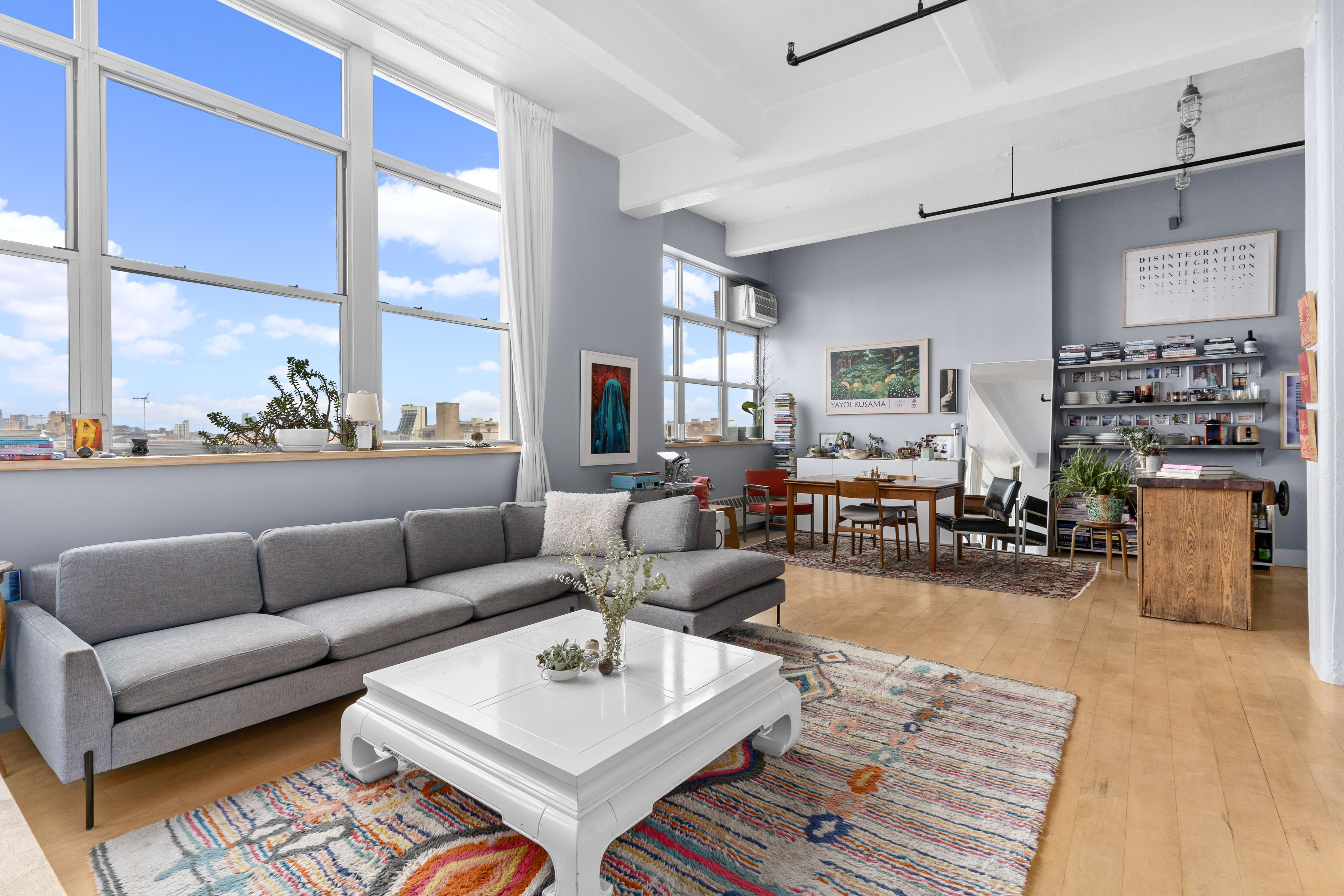 a living room with furniture wooden floor and a large window