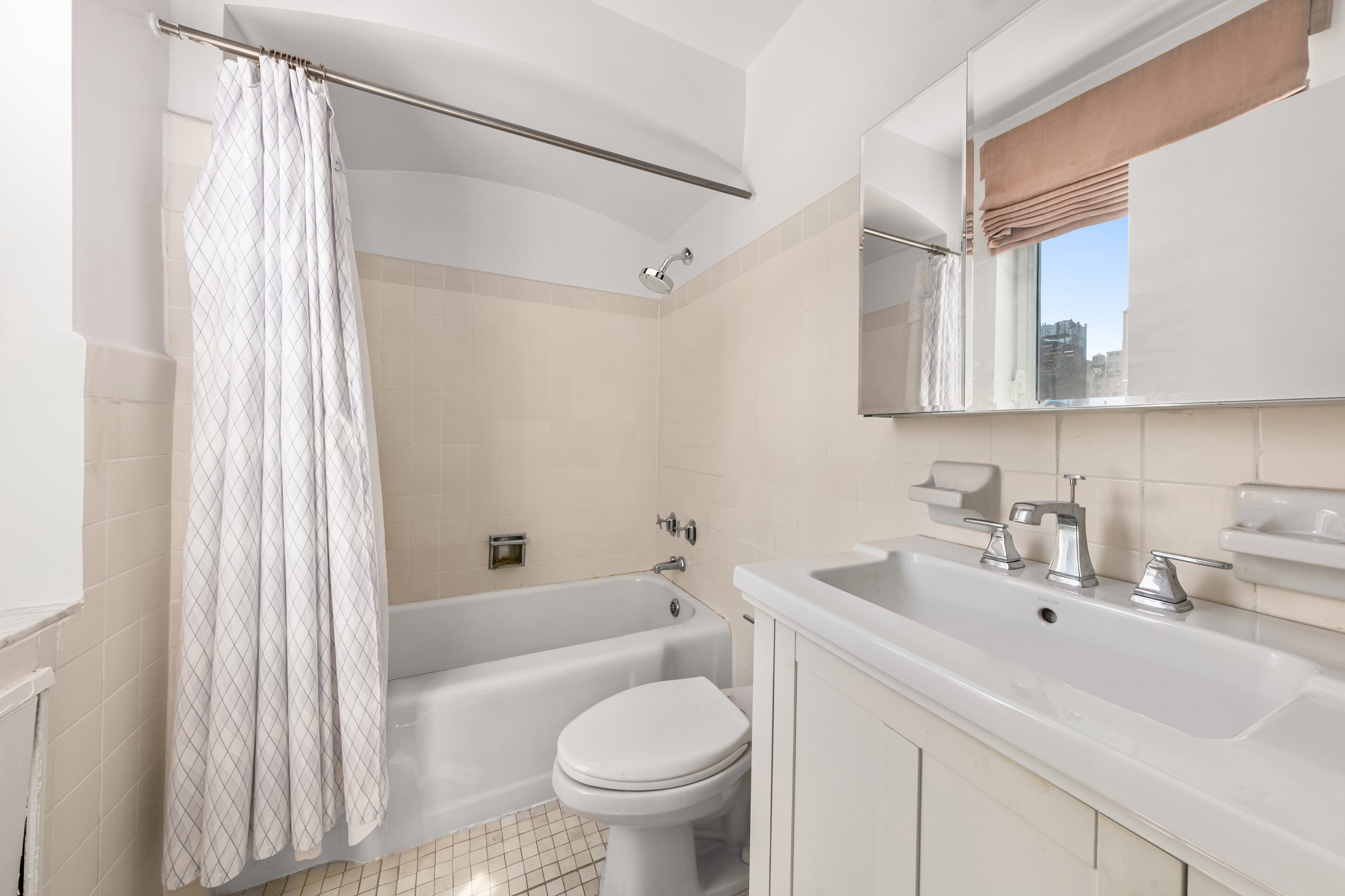 923 5th Avenue, Unit 10F Manhattan, NY 10021 - Photo 16 of 18 a bathroom with a sink toilet and shower