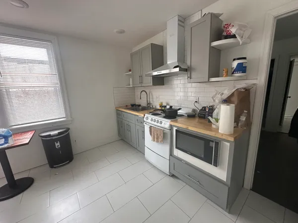 a kitchen with stainless steel appliances a stove microwave and refrigerator