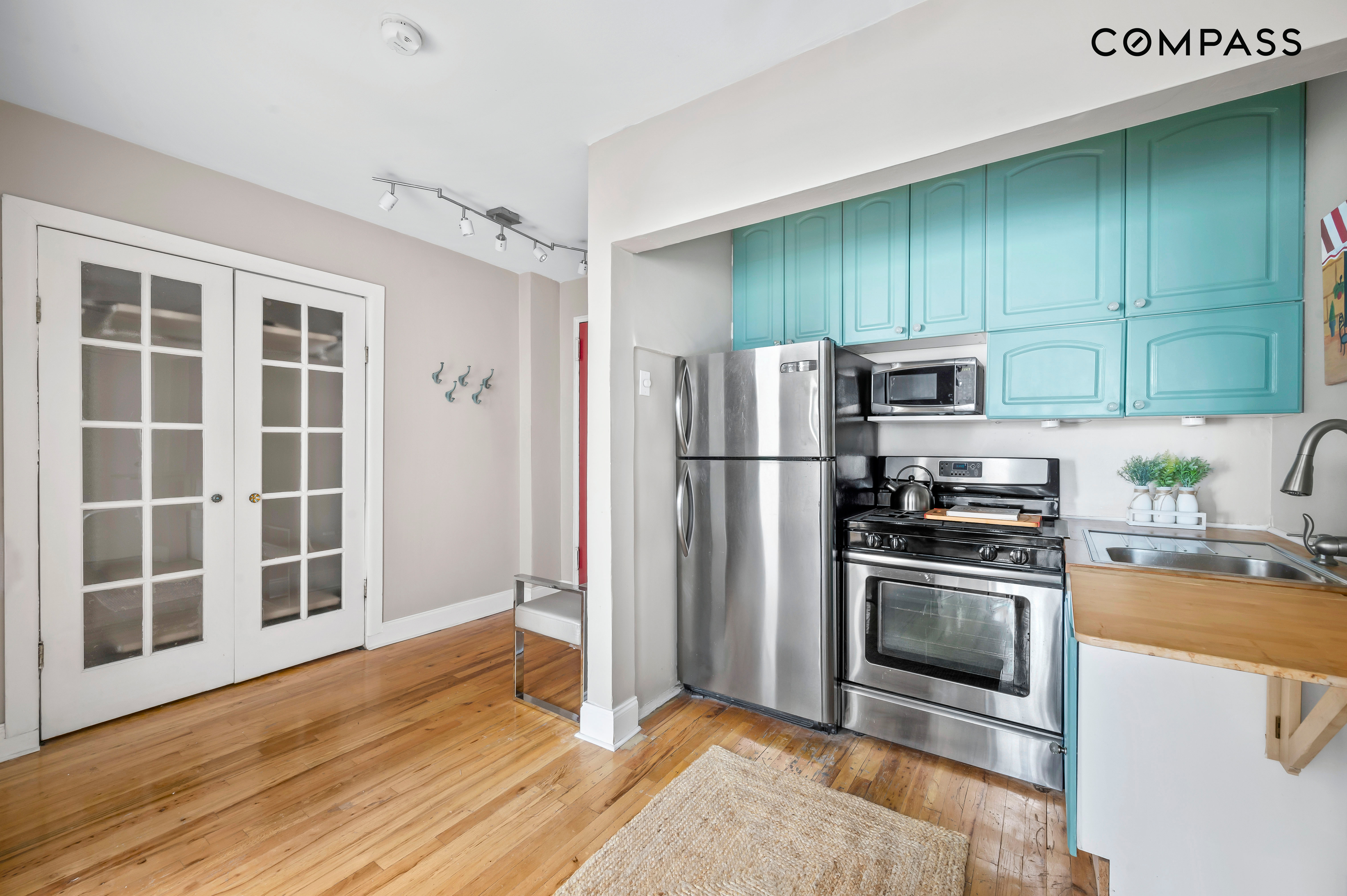 240 East 30th Street, Unit 5B Manhattan, NY 10016 - Photo 4 of 7 a kitchen with stainless steel appliances granite countertop a refrigerator stove and sink