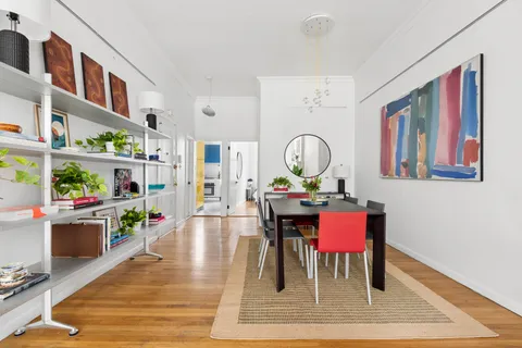 a view of a dining room with furniture and a rug
