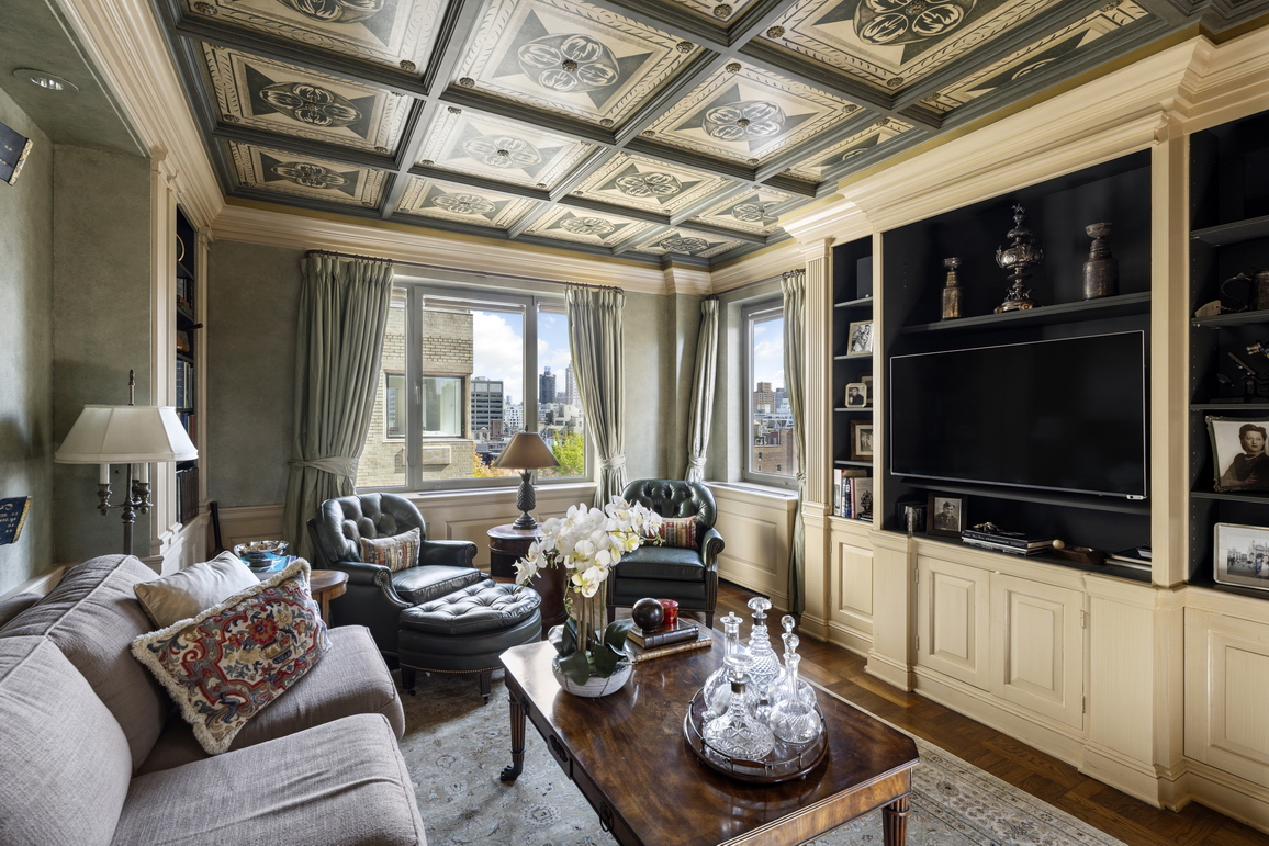 875 5th Avenue, Unit 18A Manhattan, NY 10065 - Photo 6 of 14 a living room with furniture and a flat screen tv