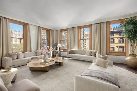 a living room with furniture and large windows