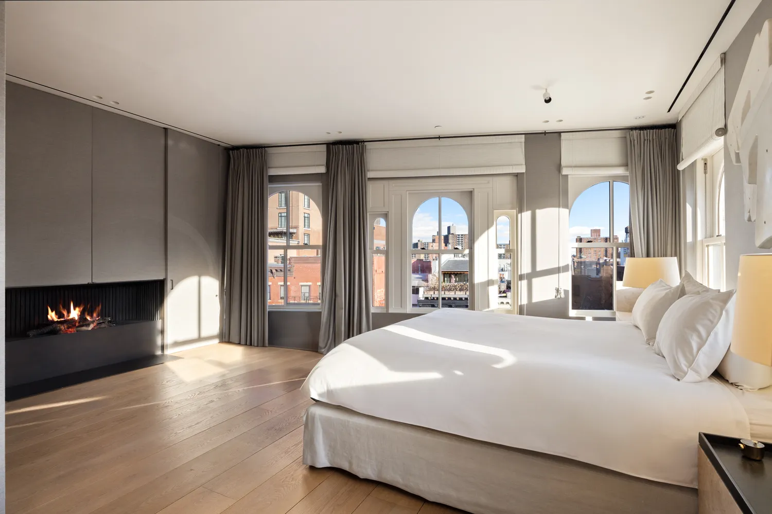 a bedroom with a large bed and a fireplace