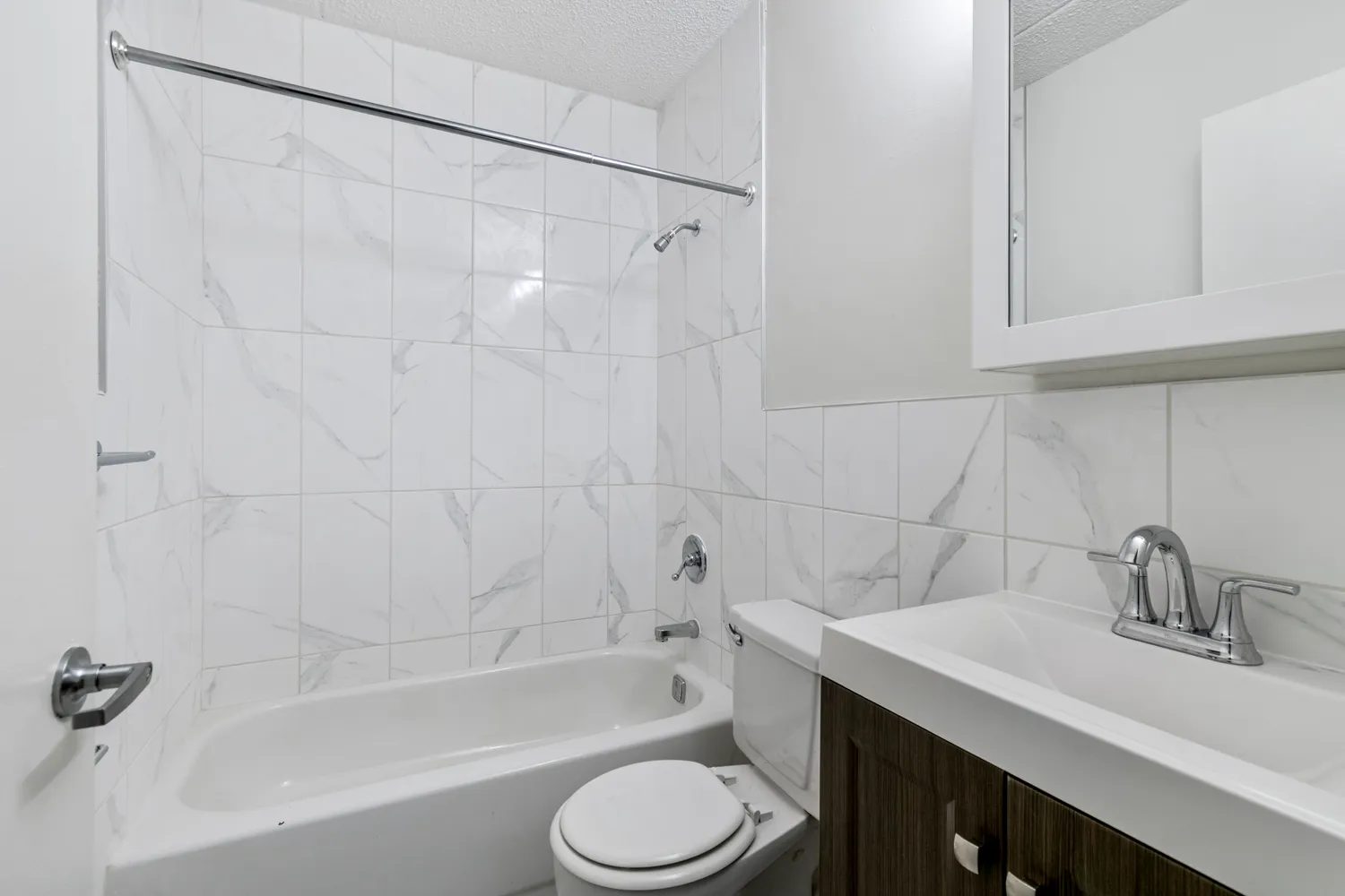 a bathroom with a sink toilet a vanity and bathtub